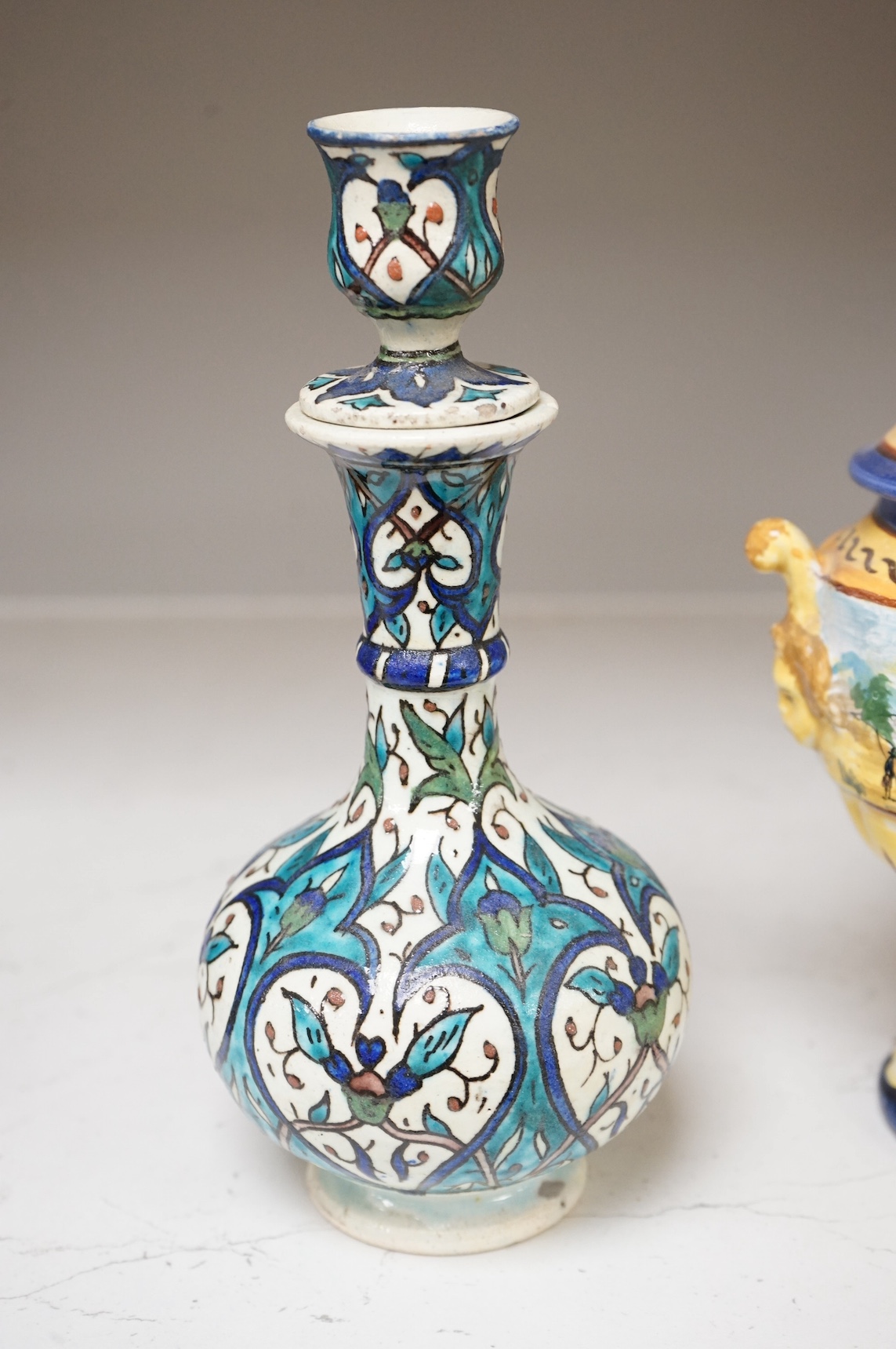 A pair of Isnik pottery vases and majolica vase and cover, largest 22cm high. Condition - fair, some restoration